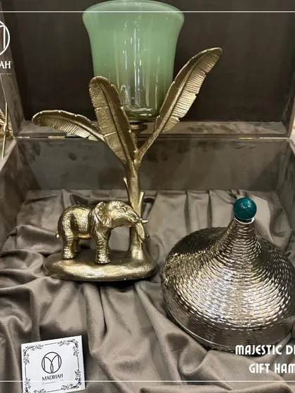 Our Majestic Diwali Gift Hamper, featuring a stunning gold-finished elephant candle holder and an ornate hammered-metal jar. This is luxury gifting designed to create cherished memories during the festival of lights.