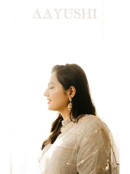 A serene solo portrait of the bride-to-be during her roka ceremony. The soft, natural light highlights her elegance and happy expression.