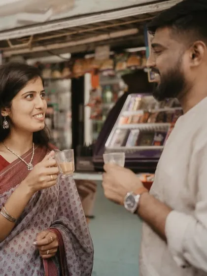 Love is often found in the simplest moments, like sharing tea at a roadside stall. We captured this candid interaction to preserve an authentic slice of the couple's life and connection.