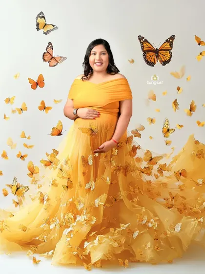 A whimsical portrait featuring a stunning yellow butterfly gown. The butterflies appear to flutter around the mother-to-be, adding a touch of magic and fantasy.