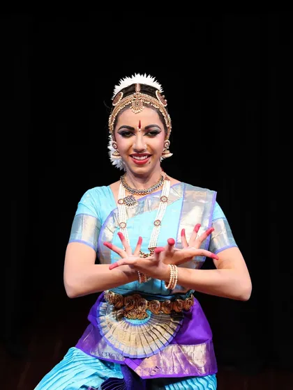Esha Arun rocked her solo debut performance at Jagriti. This close-up shot captures the intricate details of the makeup and jewelry, as well as her confident expression.