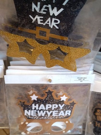 Fun and festive 'Happy New Year' party glasses. This image shows star-shaped glitter glasses and a crown design, perfect for getting into the celebratory spirit.