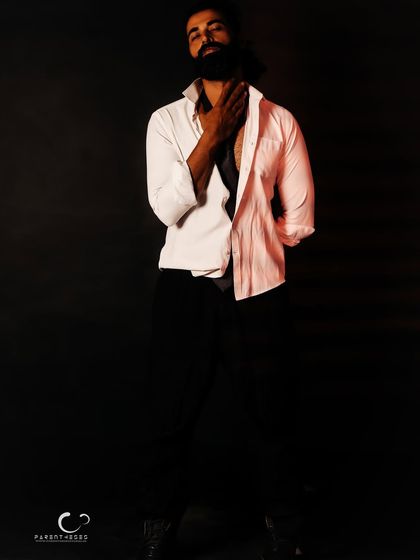 A portrait that speaks of vulnerability and strength. The unbuttoned shirt and the hand to the neck create a sense of raw, unguarded emotion.