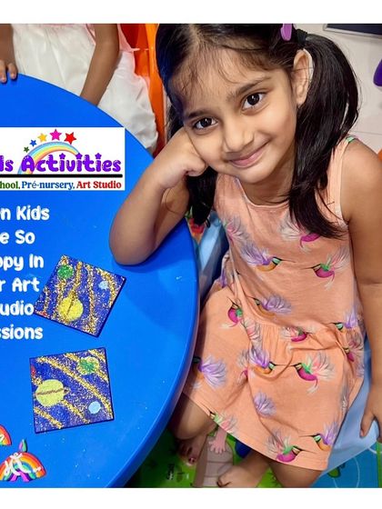 The happy face of a young artist in our studio session. She is delighted with her glittery galaxy-themed coasters. Our goal is to make every art experience joyful and rewarding.