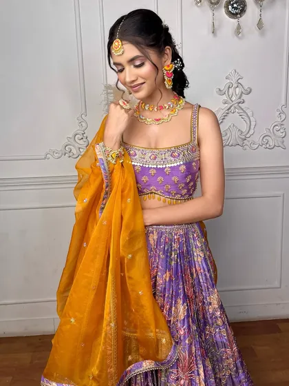 A full view of the 'Khushnuma' look, showing how the makeup complements the colorful lehenga and messy braid. It's a look that is both traditional and modern.