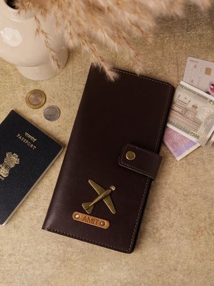 My personalized travel wallet is designed for convenience, with space for a passport, cash, and cards. This one is customized for 'Amit' with an airplane charm.