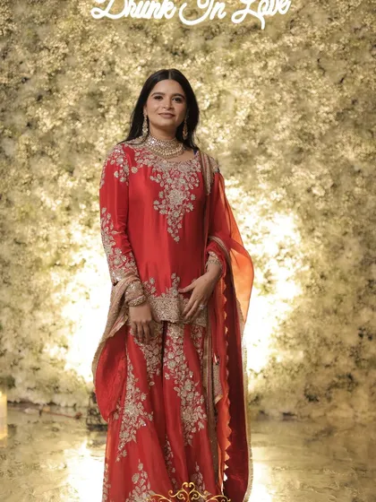 The beautiful bride posing in front of the "Drunk In Love" photo wall.