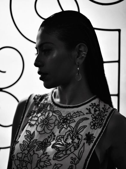 A profile shot of Anasuya Sengupta in black and white. The strong contrast between light and shadow sculpts her features beautifully.