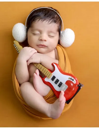 Adding tiny headphones to the musician theme for an extra touch of cuteness. These simple prop additions can personalize any classic session.