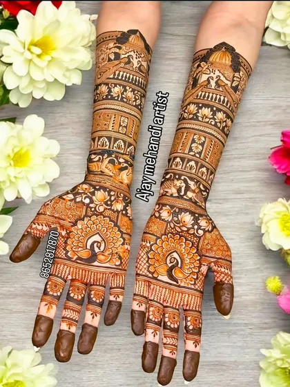 A beautiful bridal design with peacock motifs on the palms and detailed patterns extending up the arms. The use of flowers in the background highlights the festive nature of the art.