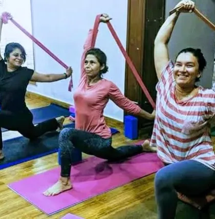 The energy in our group sessions is incredible. Here, we are using resistance bands to deepen the stretch in a lunge variation, building strength and flexibility together. It is all about progress, not perfection, and sharing a smile along the way.