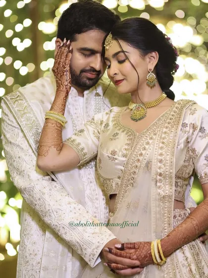An intimate moment between the couple. This close-up highlights the bride's glowing skin and soft, romantic makeup.