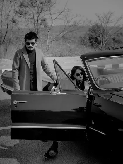 A black and white photo capturing a classic moment of him opening the car door for her. It’s these small, chivalrous gestures that add a layer of romance to the story.