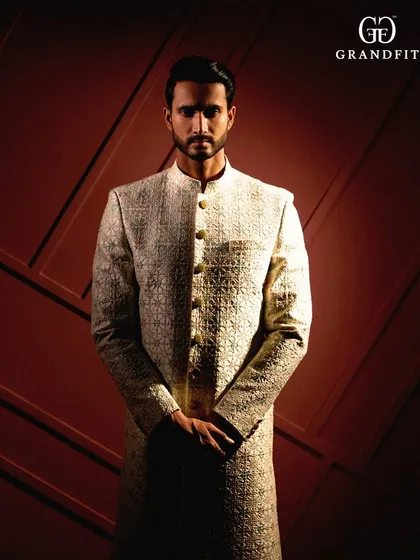 A closer look at the artistry of our craftsmanship. This image highlights the detailed, textured embroidery on a bespoke sherwani, a testament to our commitment to sartorial excellence.