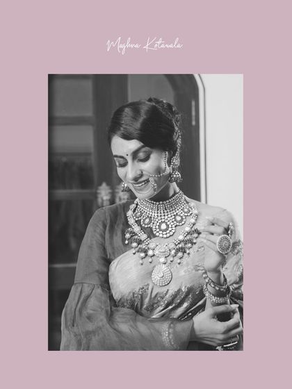 A vision of bridal enchantment. This black and white photo captures the bride's serene smile and the stunning detail of her layered polki and pearl necklace.