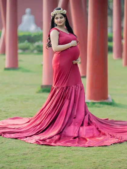 A full-length shot showcasing the beautiful train of this red mermaid-style gown.
