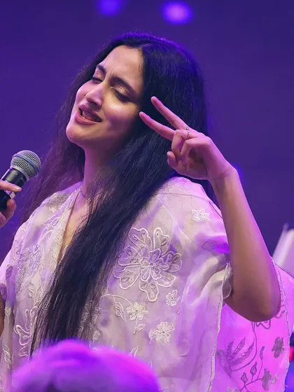 Flashing a peace sign to the audience during a fun Garba performance. It's all about spreading good vibes and celebrating music together.