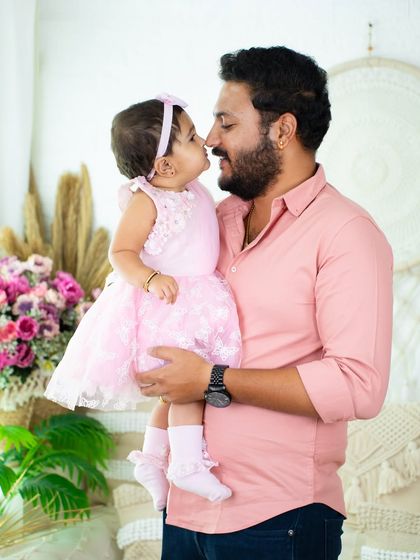 An adorable nose-to-nose moment between a father and his daughter. Their loving connection is the heart of this photograph.