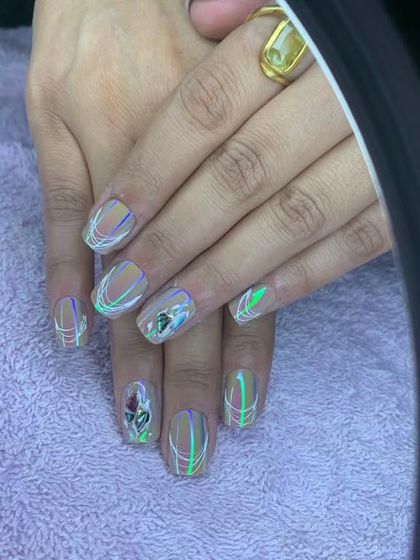 A unique design with a nude base, rainbow chrome lines, and a 3D rose accent.