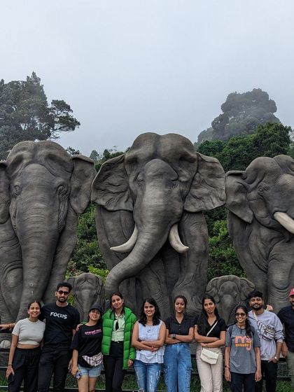 Posing with the elephant statues, a popular landmark in Kodaikanal.