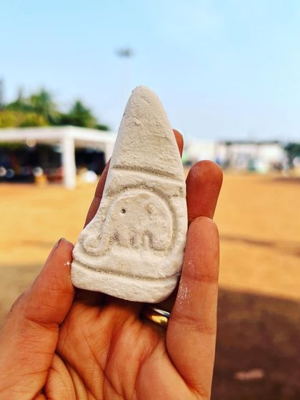 A tiny, intricate carving of an elephant, demonstrating the detailed work possible even on a small scale.