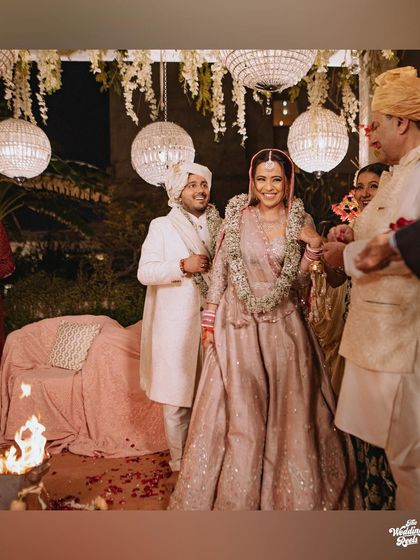 The couple walking around the sacred fire, with family members looking on with joy.