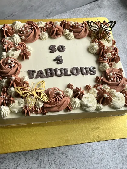 Fifty and fabulous. This large square cake is perfect for a big celebration, decorated with beautiful buttercream rosettes in shades of chocolate and cream, and elegant butterfly toppers.