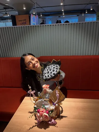 The birthday girl posing with her custom black and silver rose bouquet and personalized hamper. A perfect photo op moment.