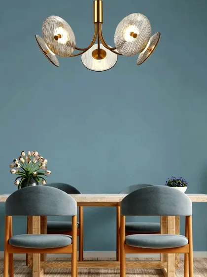 This unique pendant with textured glass discs hangs delicately over a dining table. It's a perfect example of how luxury lighting can transform a simple meal into a special occasion.