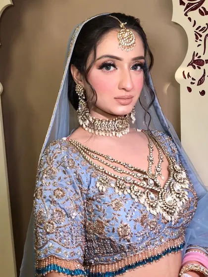 Another angle of the powder blue bridal look, showing how the heavy kundan jewelry sits perfectly on the intricate blouse.
