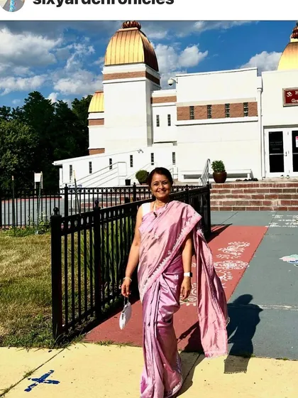 A full-length view of the client wearing the elegant pink saree with single-color Kutchwork. The embroidery adds texture and detail without overwhelming the beautiful shaded silk.
