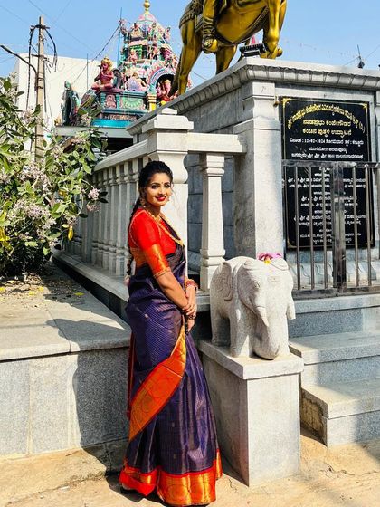 Pooja turns to the camera, her traditional braid and beautiful saree creating a look of timeless grace.