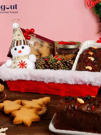 My Winter Wonderland Christmas Hamper brings the festive spirit to life. It combines a classic plum cake, assorted cookies, and other holiday treats in a charming snowman-themed basket, showing how I tailor hampers for every celebration.