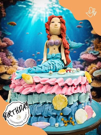 Dive into a magical underwater celebration with this stunning mermaid cake. It features a beautifully sculpted mermaid, colorful coral, and delicate seashells, creating an enchanting scene.