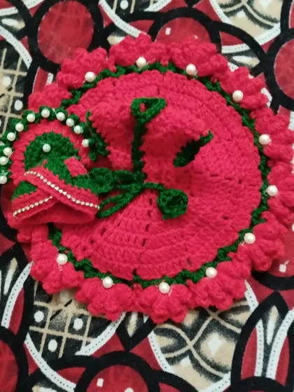 This bright pink poshak is perfect for winter. It features a green border, pearl embellishments, and comes with a matching cap for a complete look.
