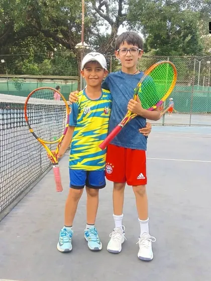 Two young boys with their rackets, embodying the fun and competitive spirit of junior tennis at the MSSA tournament.