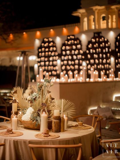 A tablescape from the 'Muted Melodies' sangeet, featuring earthy textures, dried florals, and soft candlelight. The design focused on creating a contemporary and intimate dining experience.