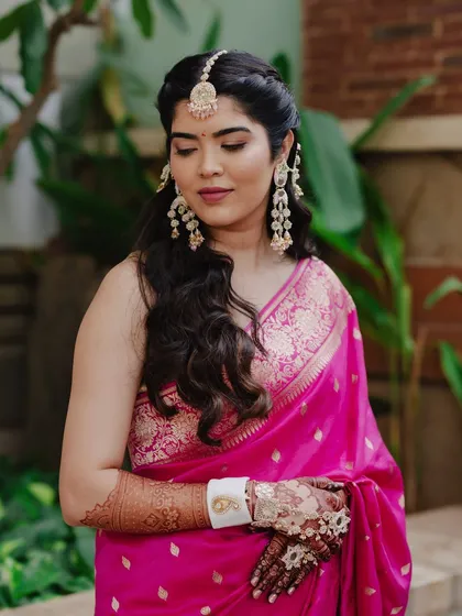 A close-up showing the details of the handcrafted jewelry and soft makeup for this Haldi look.