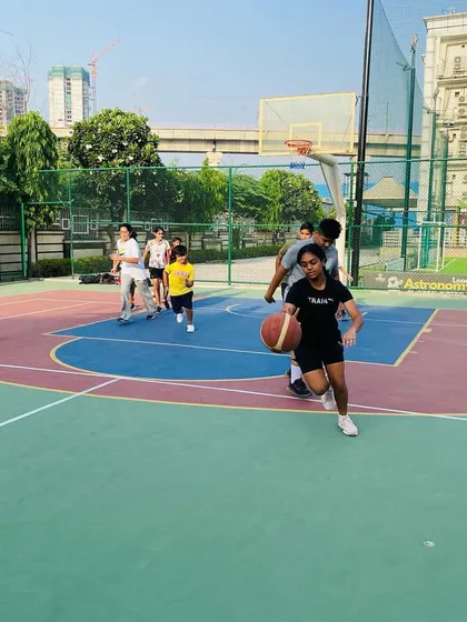 A female player dribbles the ball up the court.