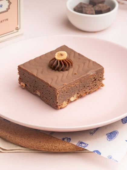 The Chocolate Hazelnut brownie is rich and nutty, with a smooth chocolate topping and a whole hazelnut for garnish.