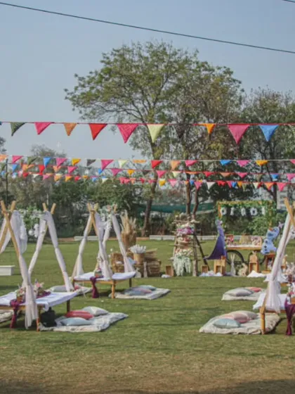 Imagine your next celebration set up like this. We create beautiful, relaxed picnic and party settings with charming teepees and colorful bunting, perfect for making memories in the open air.