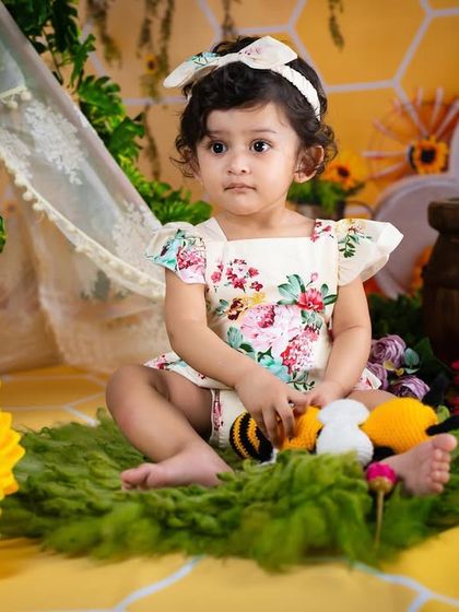 The queen bee sitting on her throne of grass, surrounded by her little bee friends and sunflowers.