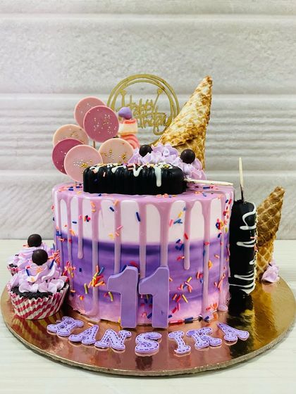 A still shot of the impressive ice cream themed cake, complete with cakesicles and cones.