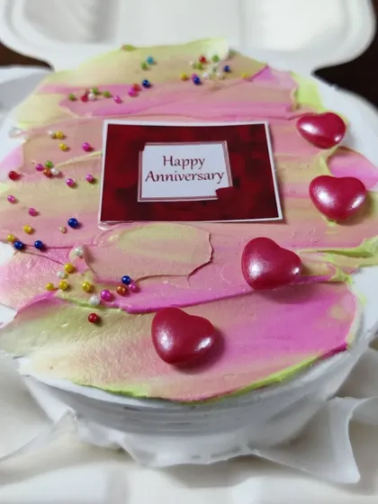 For a more intimate celebration, I offer these personal-sized bento cakes. This one was for an anniversary, decorated with a simple, modern frosting design, heart-shaped candies, and a custom message topper.