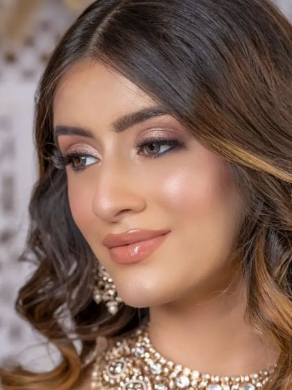 A close-up of the sangeet makeup, showing the delicate shimmer and flawless skin. This look is all about creating a radiant glow that lasts all night.