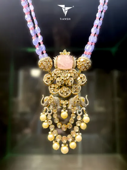 A tale of heritage, told in shimmer and soul. This necklace is handcrafted in gold, with polki that catches light like morning dew and two elephants that stand as guardians of grace.