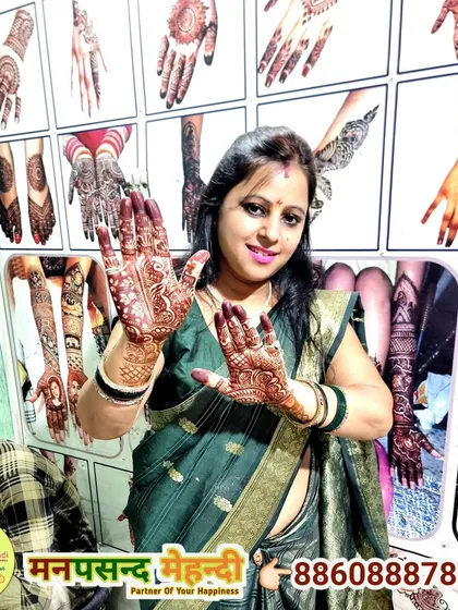 A client posing happily with her intricate mehndi design at our studio.