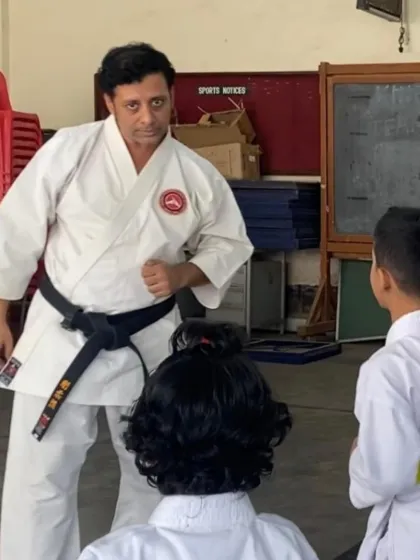 A sensei demonstrates a stance to his young students. Leading by example is fundamental to our teaching philosophy, showing the "kiddus" the power and focus required in every move.