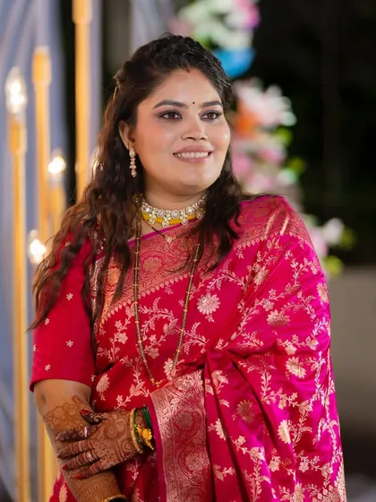 Another beautiful shot of the bride at her reception. The lighting highlights the dewy finish of her makeup.