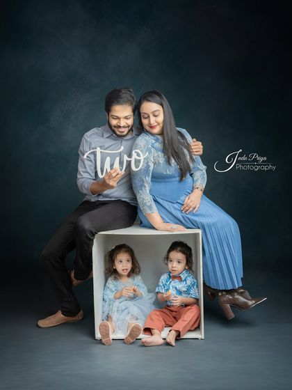 Another shot from the twins' birthday session, this one showing the mother's baby bump, celebrating both the twins turning two and the arrival of a new sibling.